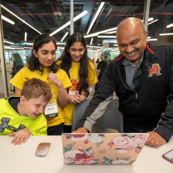 CMNS Dean Amitabh Varshney learns about CompSciConnect camper projects at Maryland Day 2024.